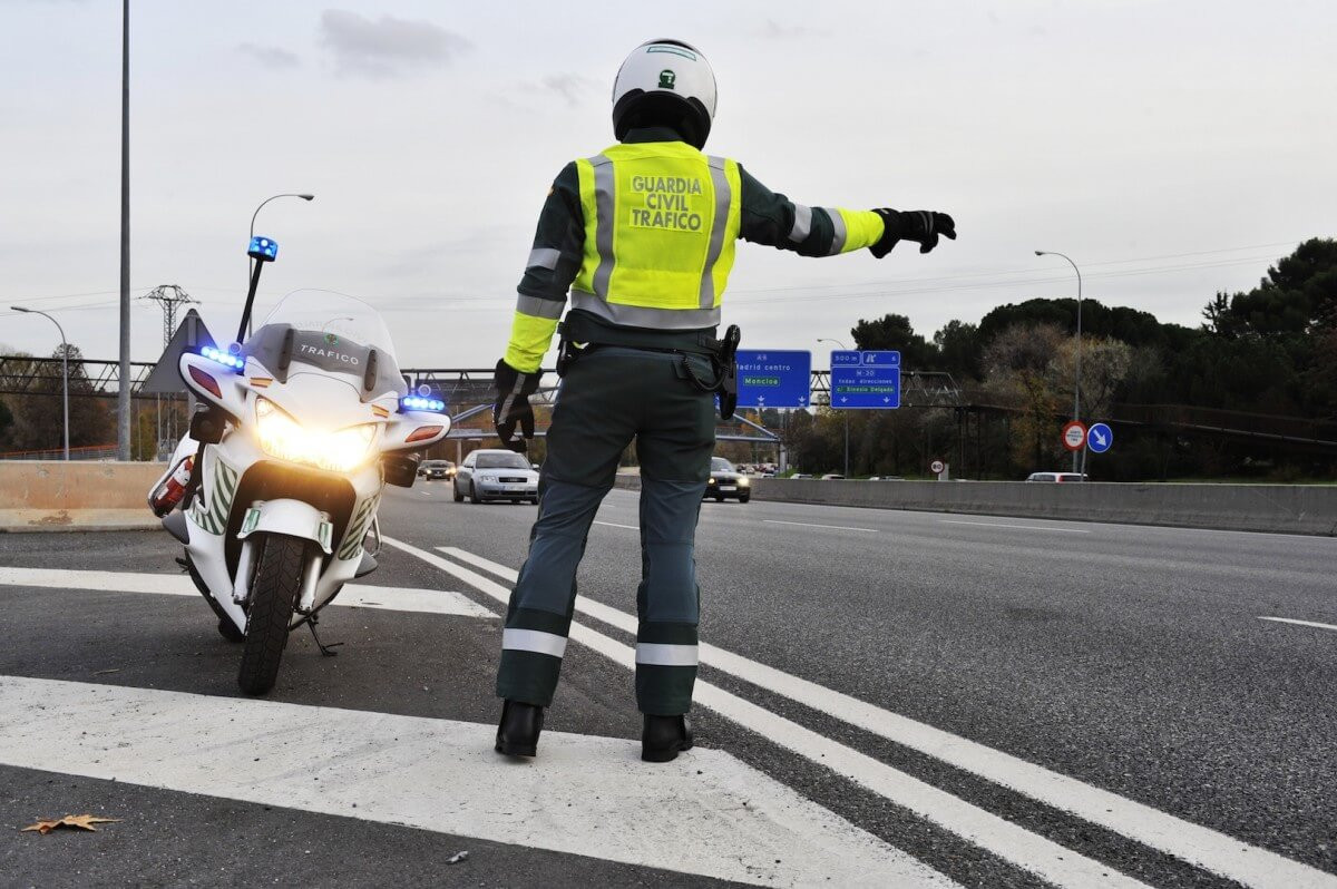 Guardia civil motorcycle officer pulling car over