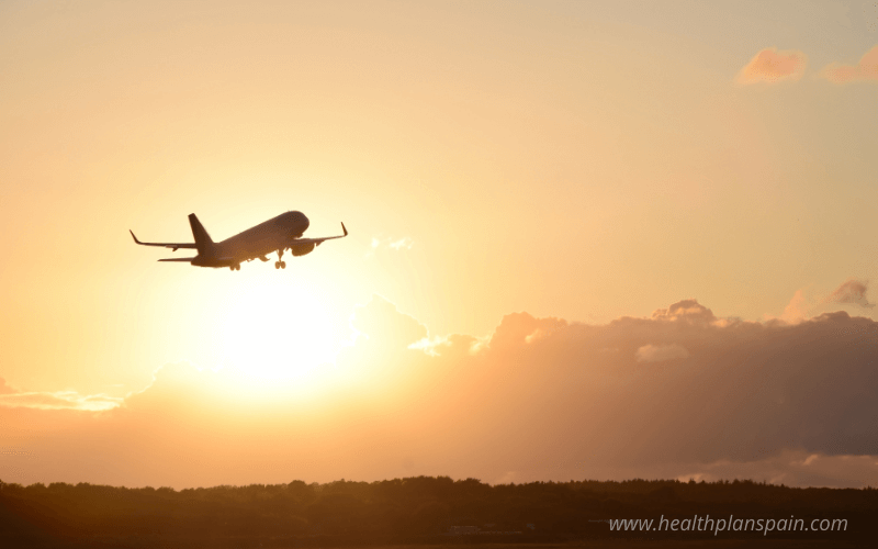 Airplane taking off with sun background