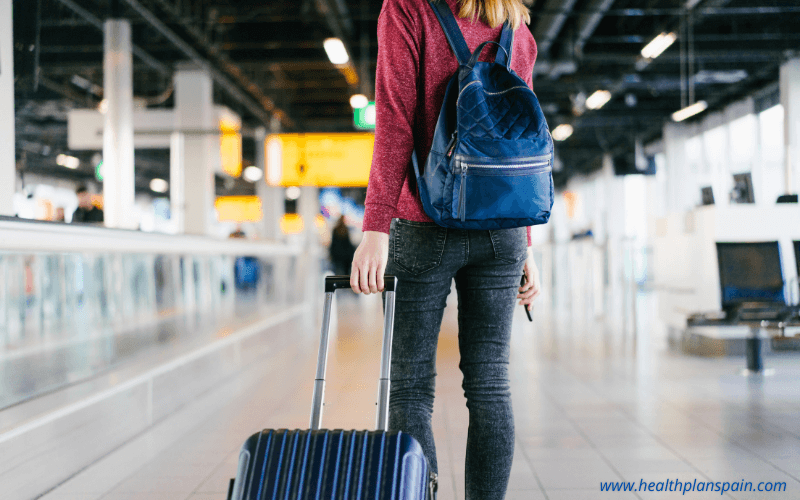 Airport passenger pulling suitcase