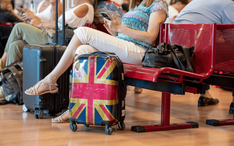 Airport passenger with UK suitcase