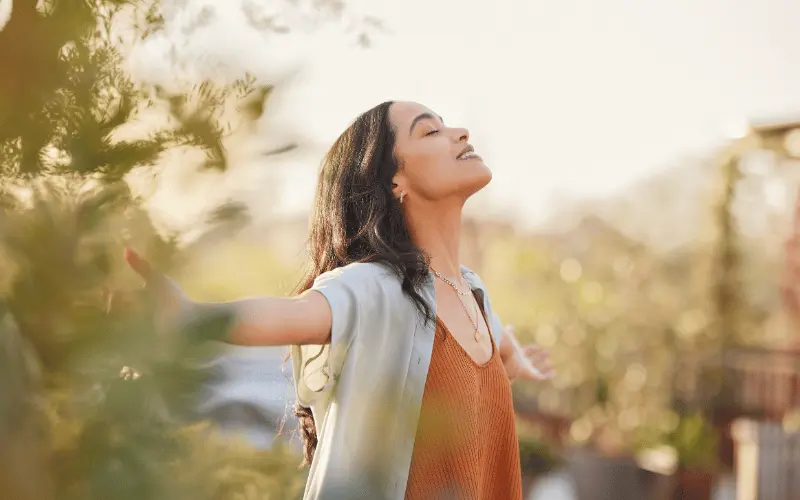 Young woman outdoors enjoying calm moment for mental health and anxiety relief