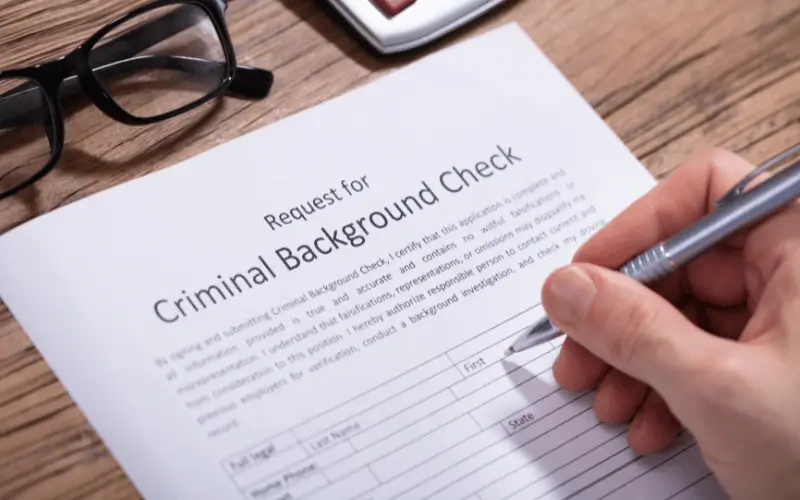 Person filling out criminal background check form