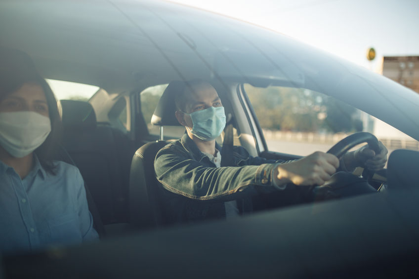 Driver and passenger wearing a mask