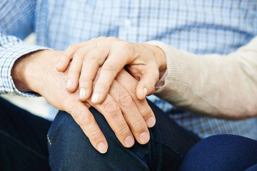 Old couple holding hands