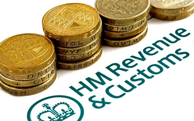 Pound coins on top of HMRC headed document