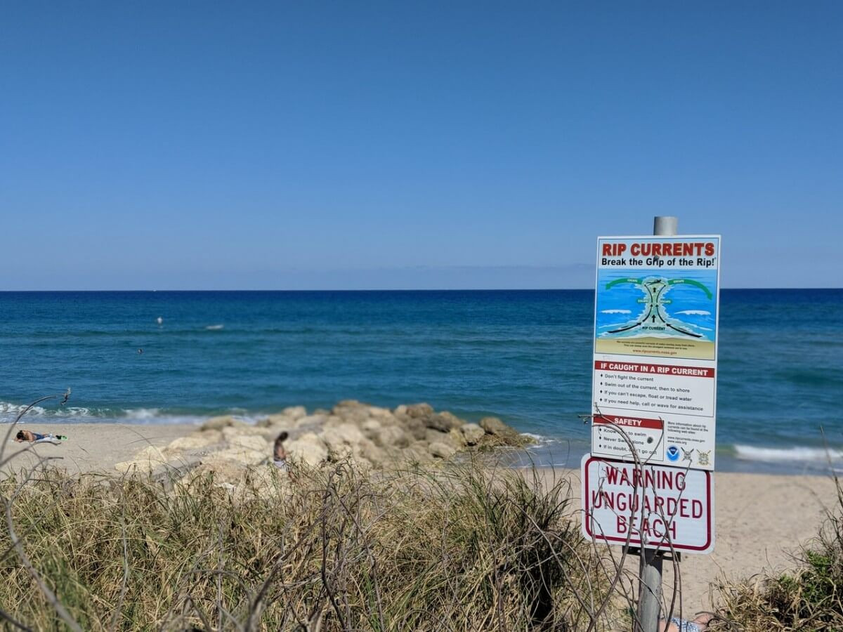 Rip currents warning sign on beach
