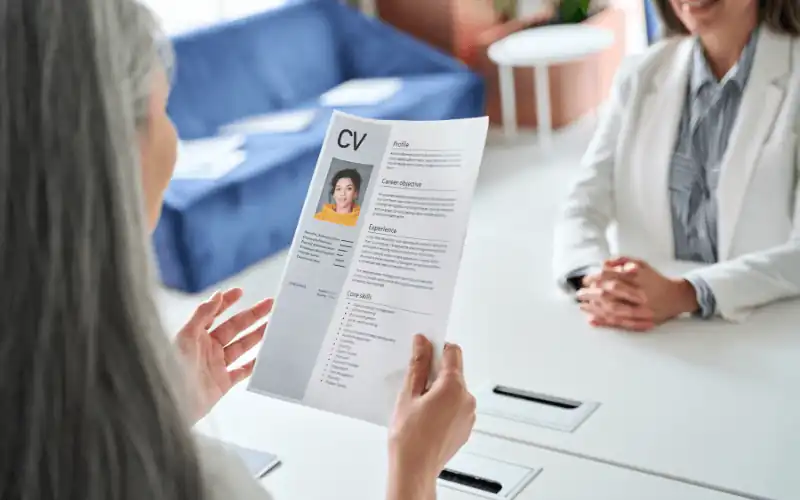 Self employed worker handing new contract to new staff member