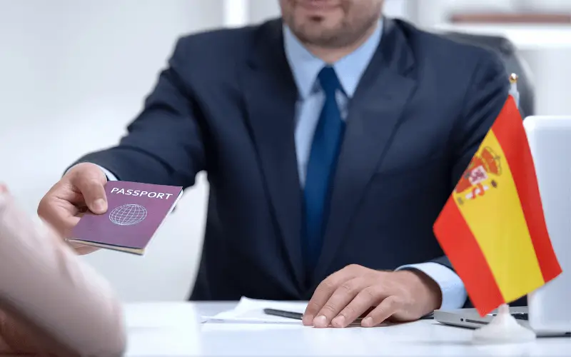 Spanish Government official passing person their passport