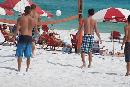 Youngsters playing beach volleyball in Spain