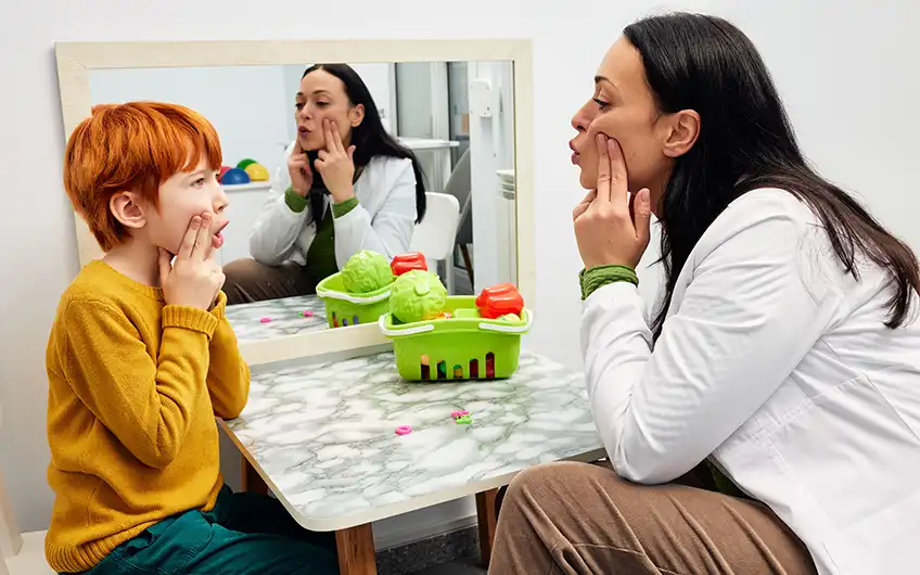 Speech therapist working with a young child