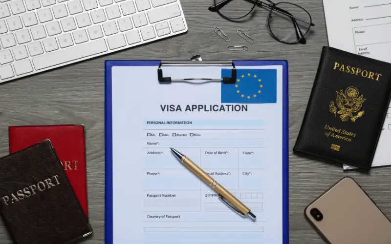 Visa application form for studying in Spain with passports on desk